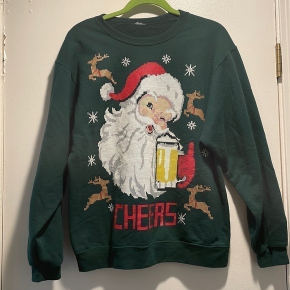 𝅺Santa Faux Cross Stitch Sweatshirt Winking Drinking a Beer saying, “Cheers!” - Picture 1 of 3